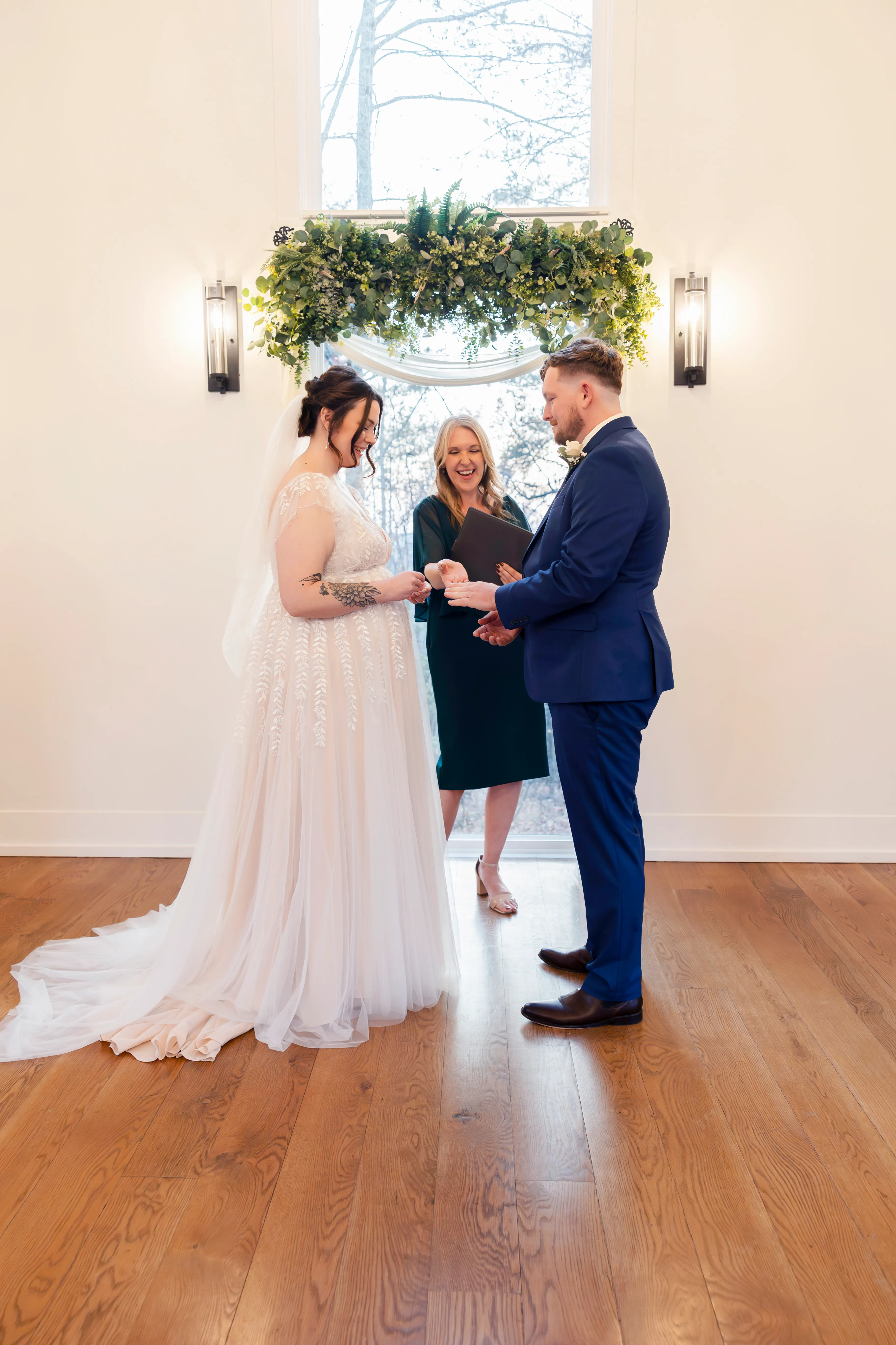 Bride and groom exchanging rings at the altar of Juliette Chapel during the ceremony