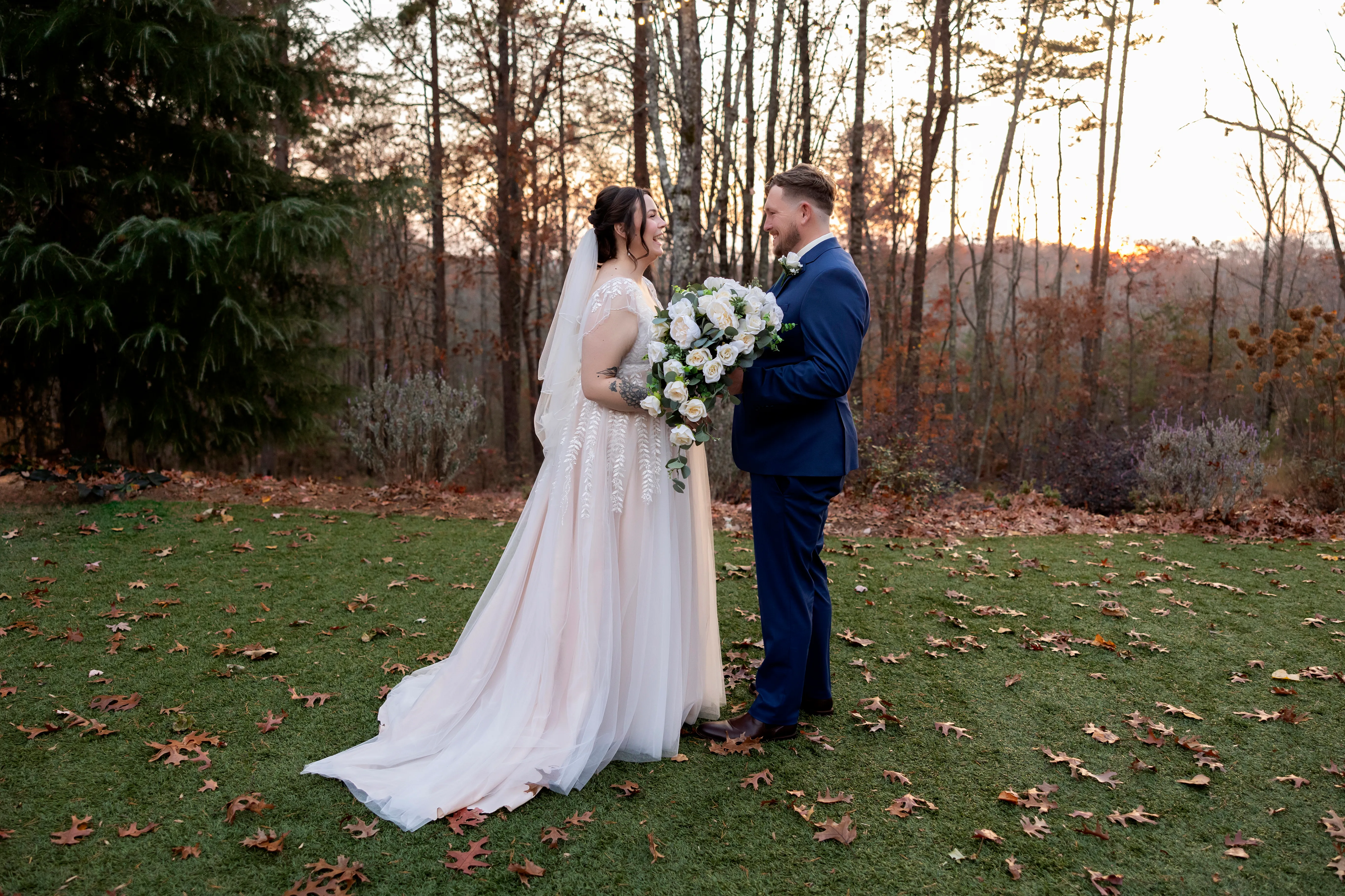 Bride and groom facing each other during outdoor portraits at sunset